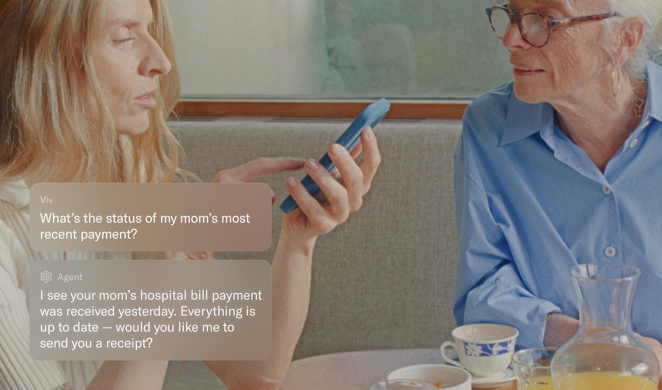 Woman helping older mother check on payment status via AI agent