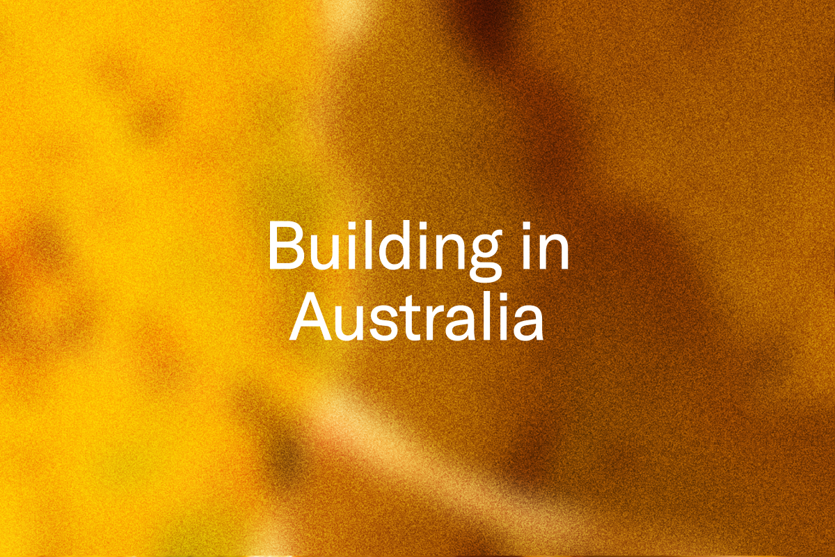 Text that reads "Building in Australia" on a blurred orange and brown background.