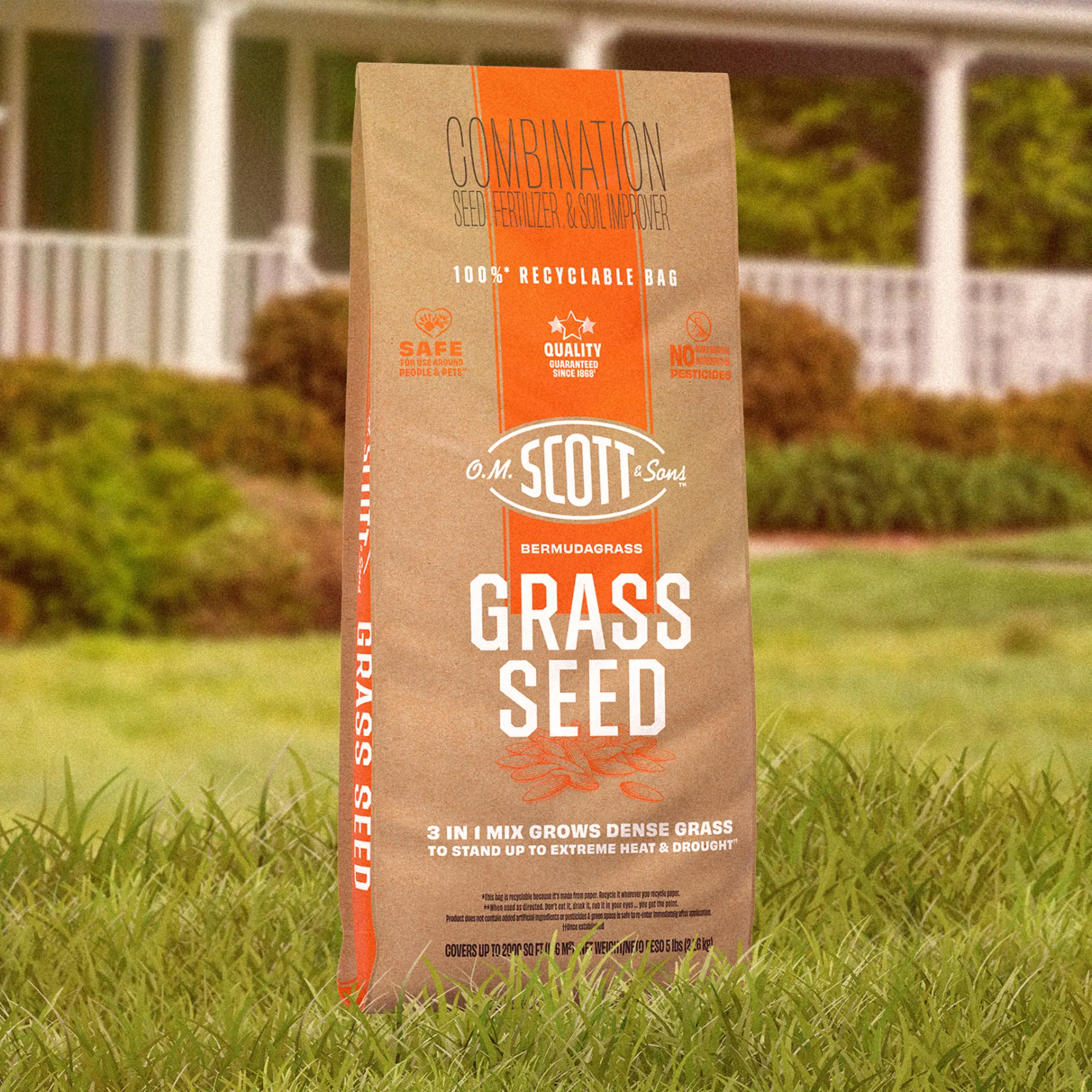 A brown bag of O.M. Scott & Sons Bermuda Grass Seed, Fertilizer & Soil Improver stands in green grass.
