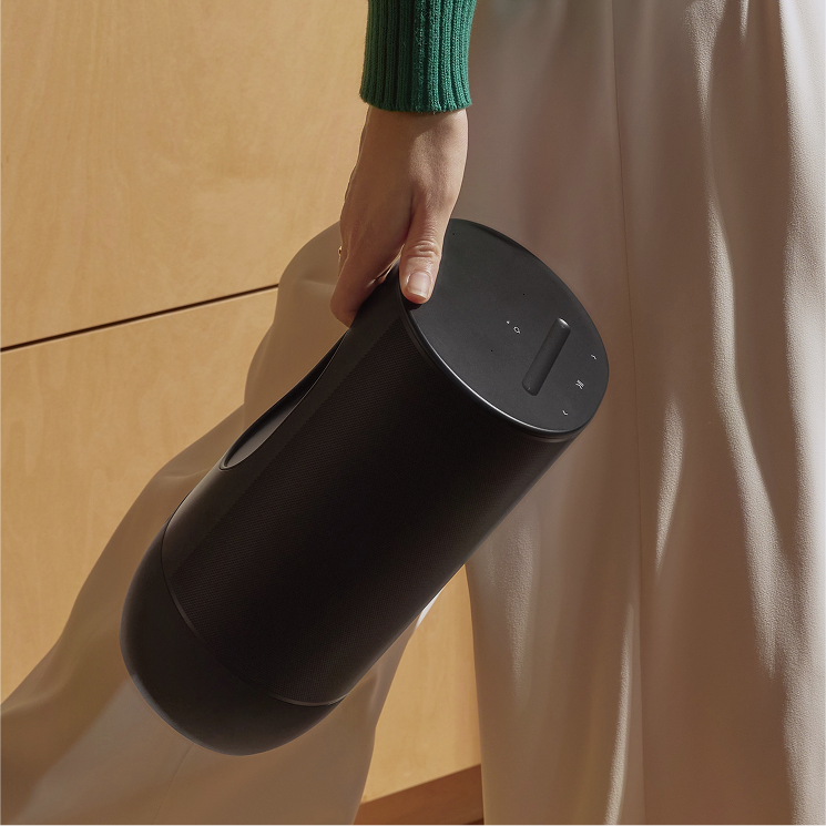 Woman walking with Sonos speaker
